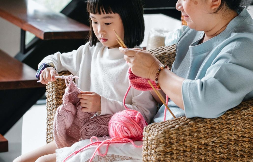 young girl and older woman crocheting