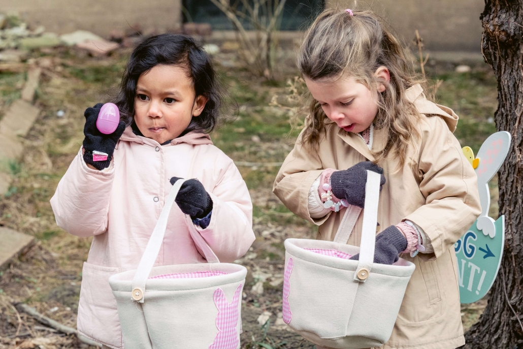 two girls outside holding easter baskets
